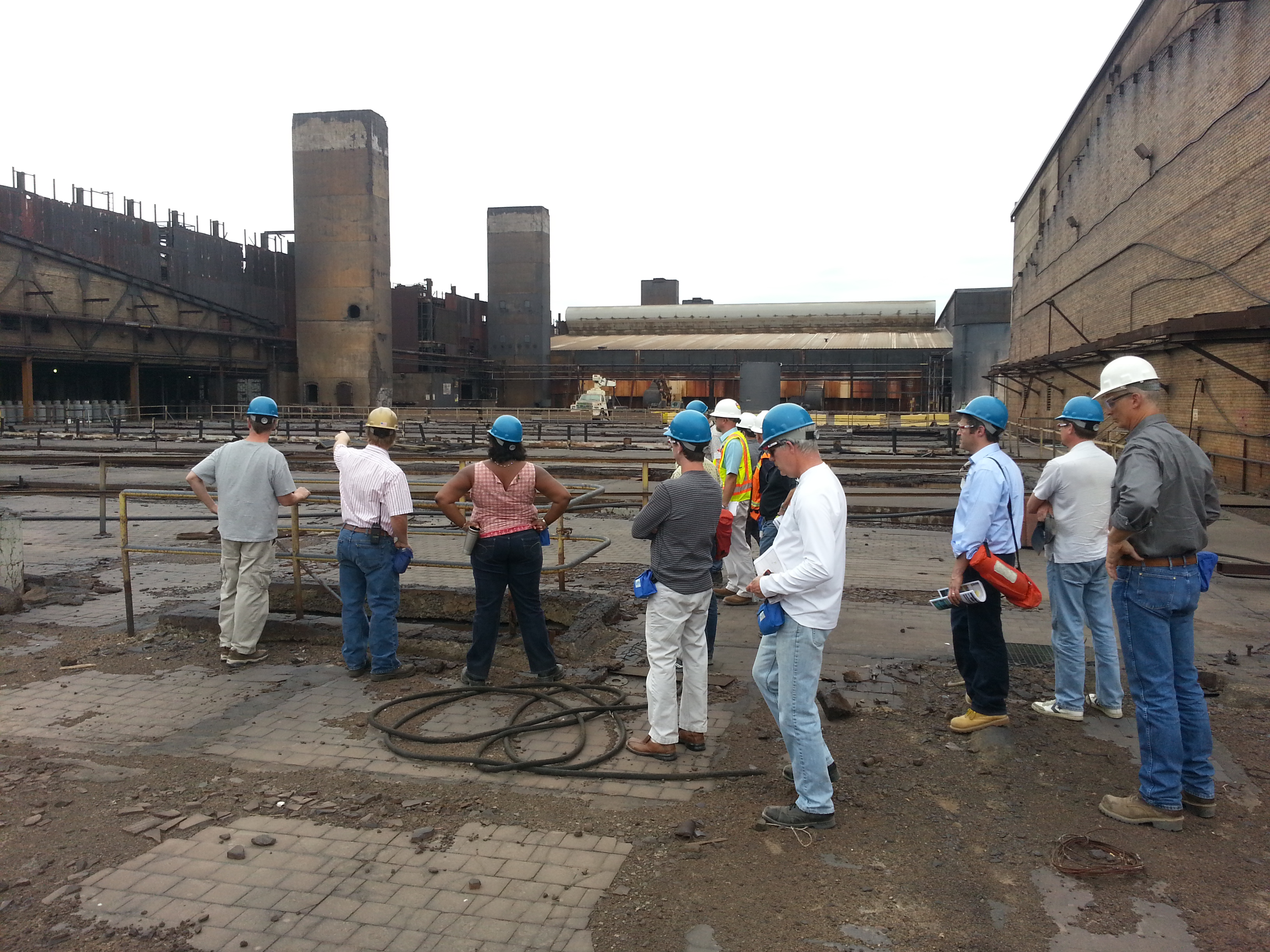 10 people tour an abandoned industrial site in the BMI complex